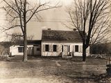an old black and white photo of a house in the country