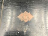 a black tray that has a gold emblem on it