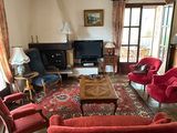 an image of a living room with red couches and chairs