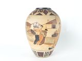a vase with a picture of a man and a woman on it