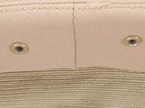 a close up of a hat with a gold button on it