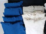 a lot of t - shirts laid out on the floor