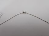 a close up of a chain on a table with a pair of scissors