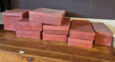 a stack of red boxes on a wooden table