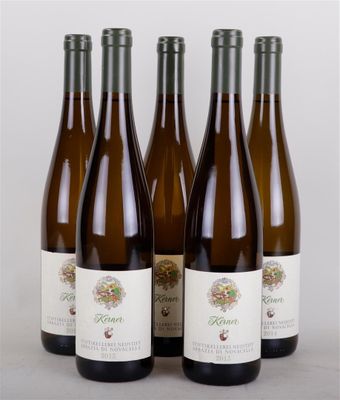 four bottles of wine are lined up on a table
