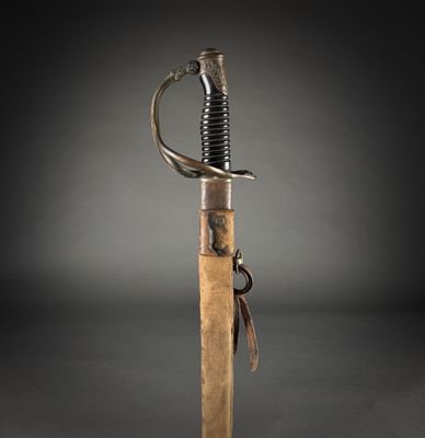 a close up of a sword with a wooden handle on a black background