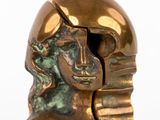 a bronze statue of a woman with a helmet on her head