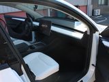 the interior of a car with the door open and the driver ' s seat down