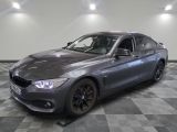 a picture of a grey bmw car parked in a showroom