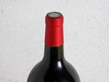 a bottle of wine sitting on a table with a glass of wine