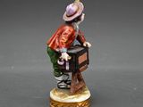 a figurine of a man sitting on a chair