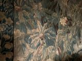 a large tapestry hanging on a wall in a room