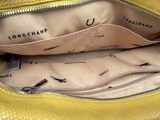 the inside of a yellow handbag with a zipper on it