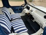 a picture of the interior of a car with a blue and white stripe seat covers
