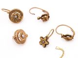 three pairs of gold earrings and a pair of gold ear rings