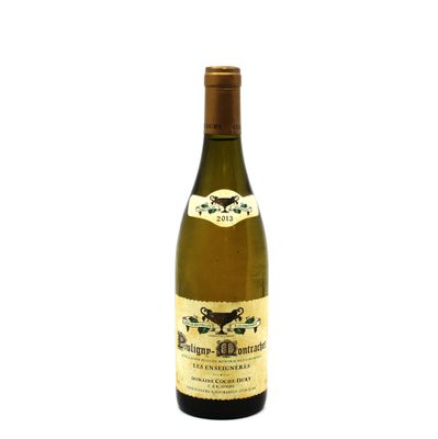 the bottle of white wine is sitting on a white surface