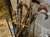 many different types of walking canes in a metal holder
