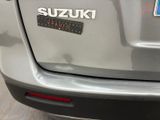 the rear end of a car with a sticker that says suzuki on it