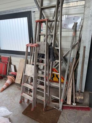 a room with a ladder and a lot of stuff on the floor