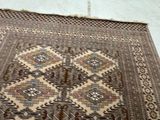 a rug on the floor with a cat sitting on top of it
