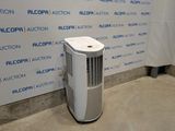 a small air conditioner sitting in front of a wall