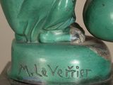 a statue of a frog that is sitting on a table