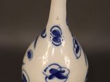 a blue and white vase sitting on a table