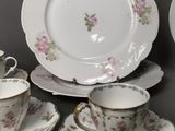 a lot of plates and cups and saucers on the table