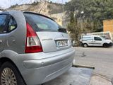 a silver car that is parked on the side of the street