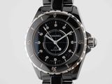 the watch is black and silver with a black face