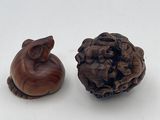 two pieces of wood sitting next to each other on a white surface