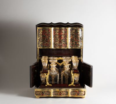 an ornately decorated wooden box with gold and red decorations