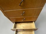 a wooden dresser with three drawers and a pull out drawer