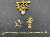 a close up of a gold bracelet with a star and a dragon