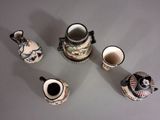five different types of vases sitting on a table