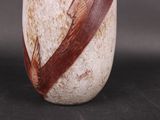 a vase with a brown and white design on it