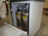 two fire extinguisors that are in a cabinet