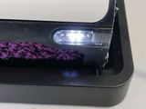 a black and white device on a table with a purple cloth