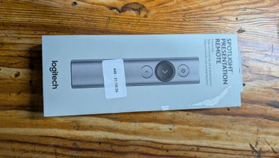 packaging of a new nintendo wii controller sitting on a wooden table