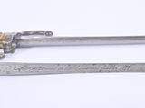 two swords with writing on them sitting next to each other