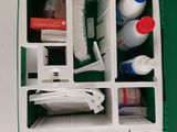 a green and white box with a lot of items in it