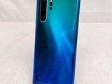 a close up of the back of a blue and green phone