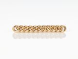 a close up of a gold chain bracelet on a white surface