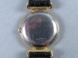 an image of a close up of a wrist watch on a white surface