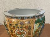 a vase sitting on a wooden table with a wall in the background