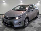 the toyota corollant is parked in a clean room with checkered flooring