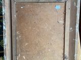 an old picture frame sitting on top of a wooden easel