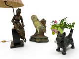 three figurines of animals and a lamp on a table