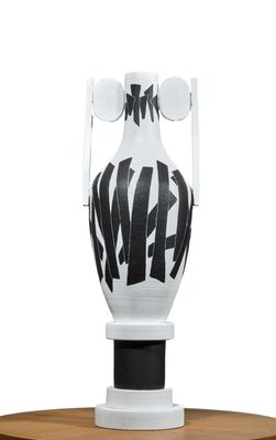 a white vase with a black and white design on it