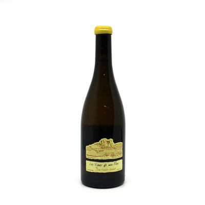 a bottle of wine sitting on top of a white table